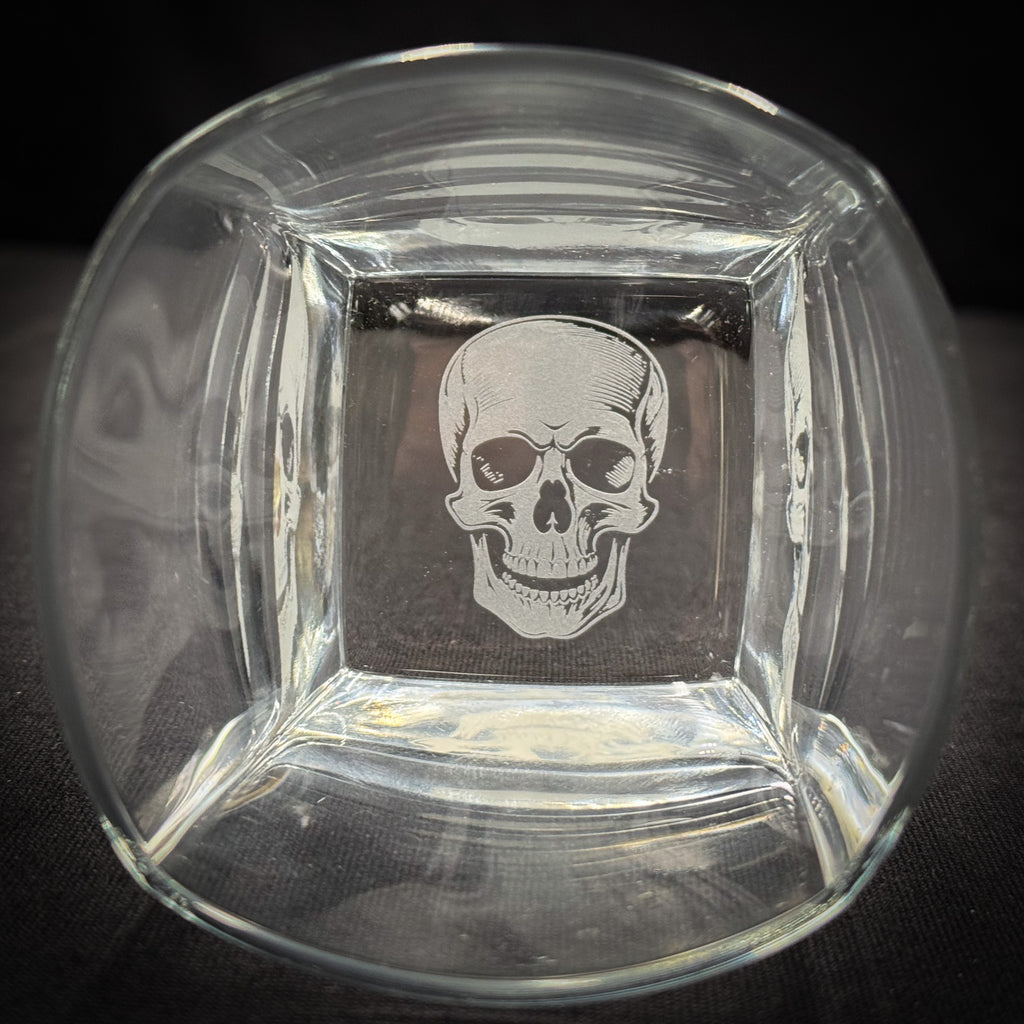 a clear glass bowl with a white skull etched into it.