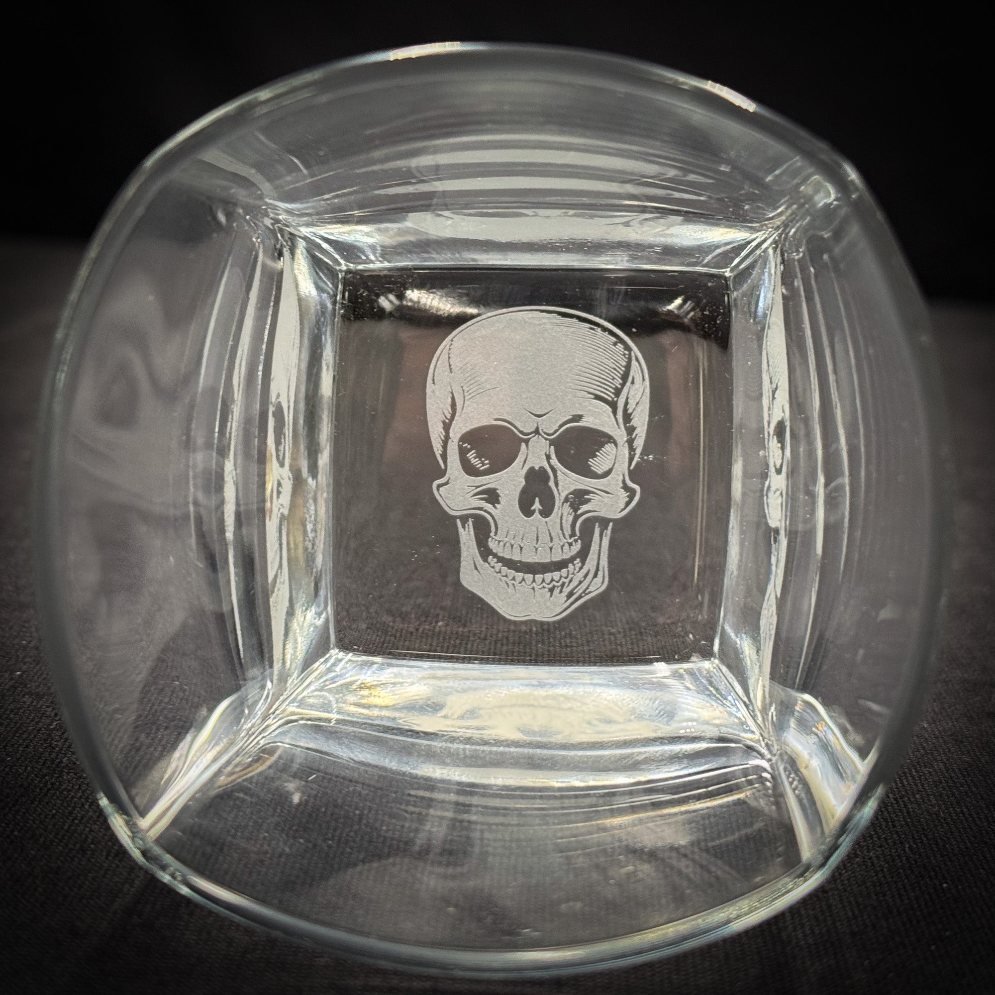 a clear glass bowl with a white skull etched into it.