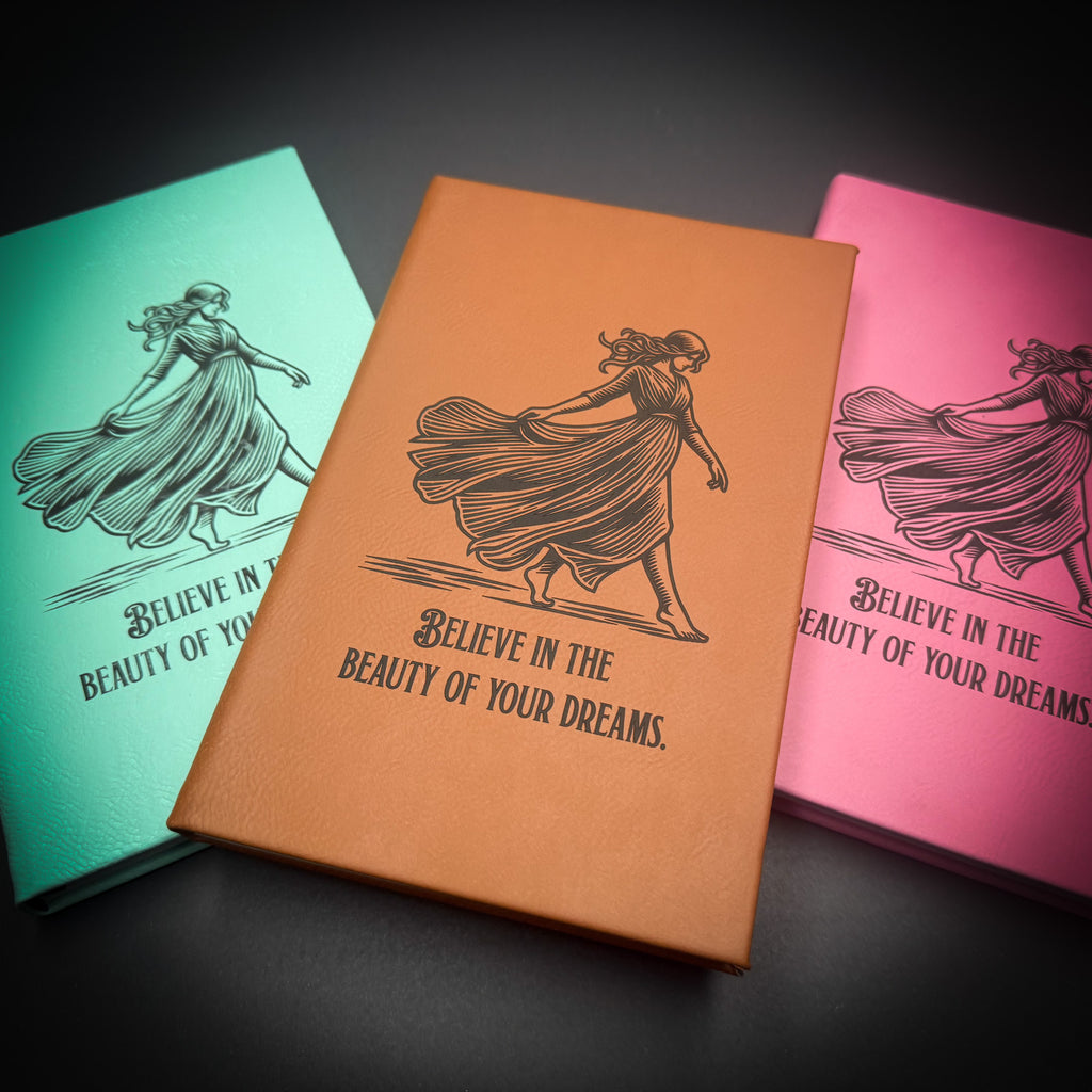 three books with a similar design, each with a woman's silhouette and the text "Believe in the beauty of your dreams" printed on them.