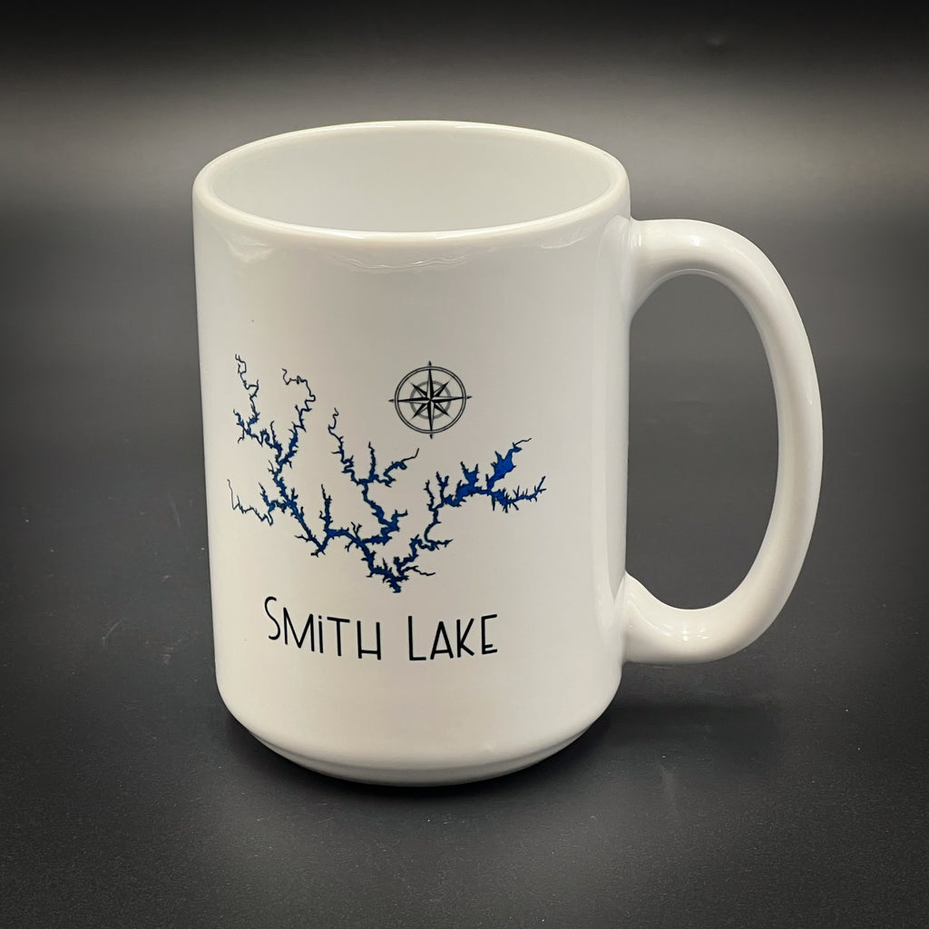A white ceramic mug with a design depicting a river or lake and the text "SMITH LAKE" printed on it.