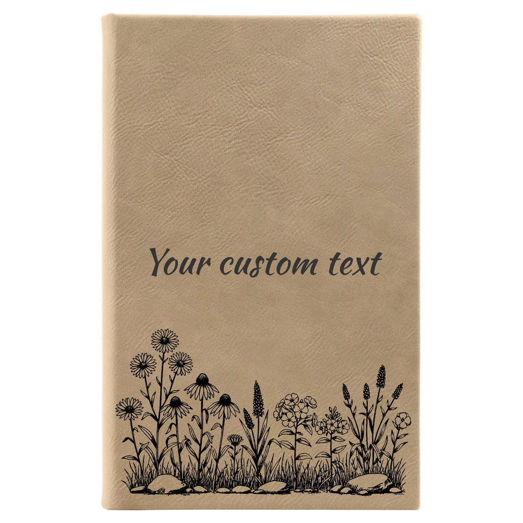 The image is a tan-colored notebook cover with a floral design and the text "Your custom text" printed on it.