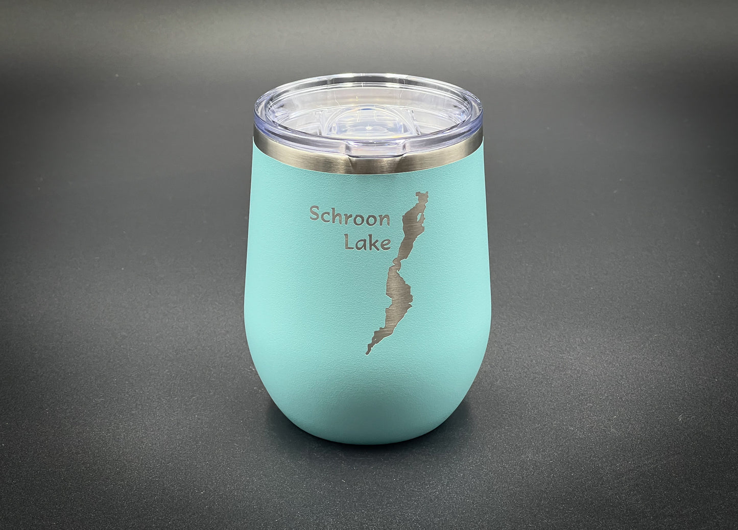 a blue cup with a silver lid on a table