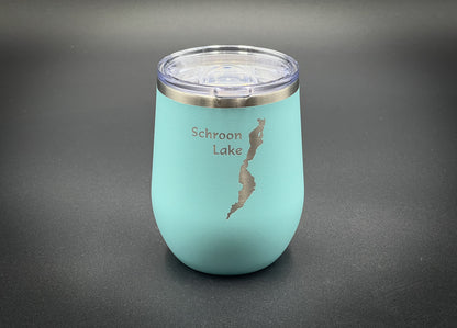 a blue cup with a silver lid on a table