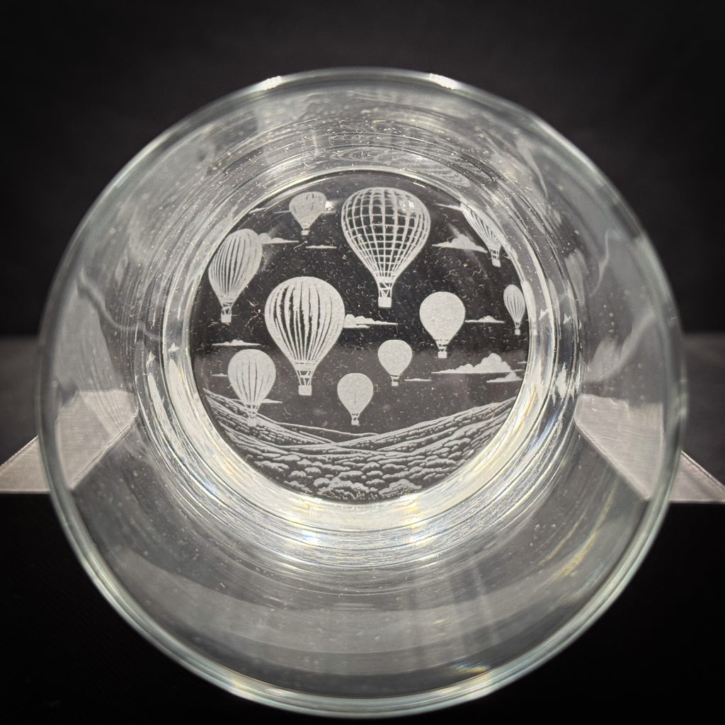 a glass with a design of hot air balloons on it.