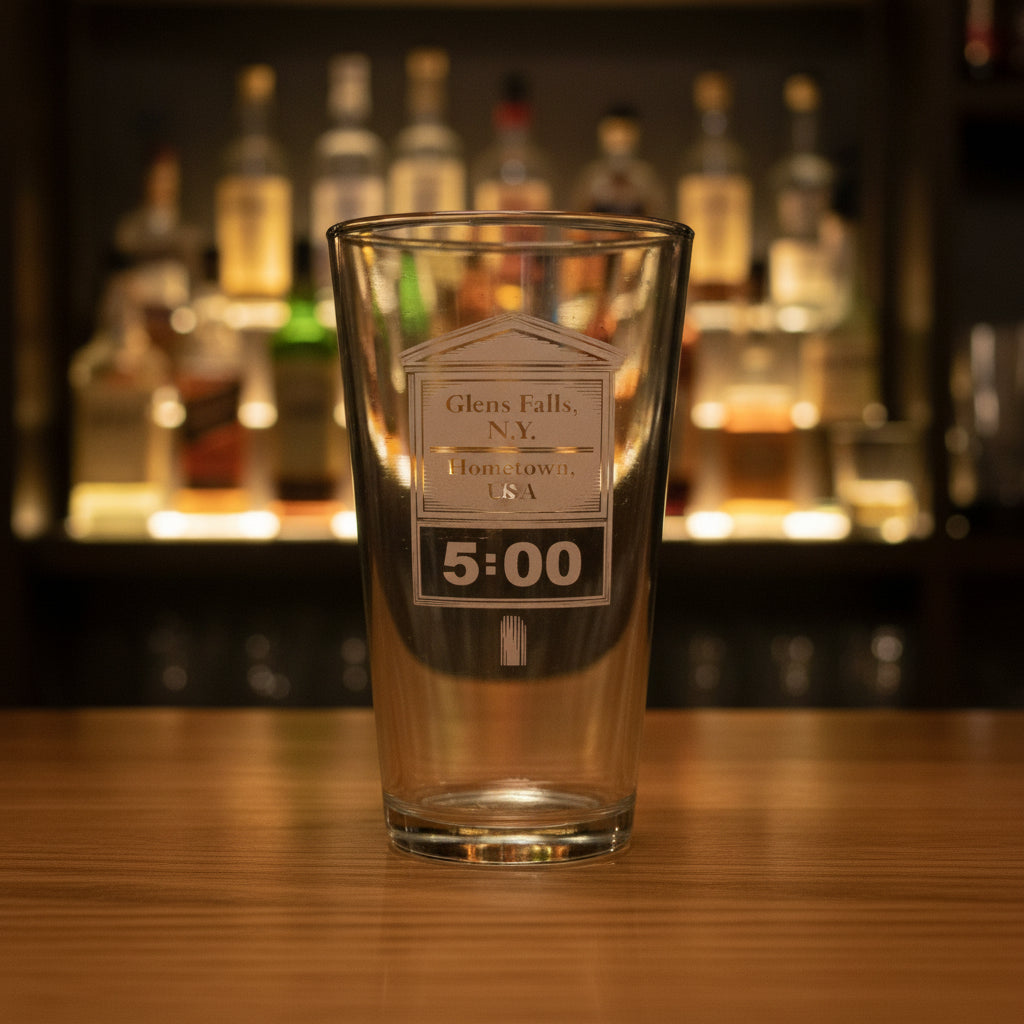 Clear glass with engraved text on a dark background