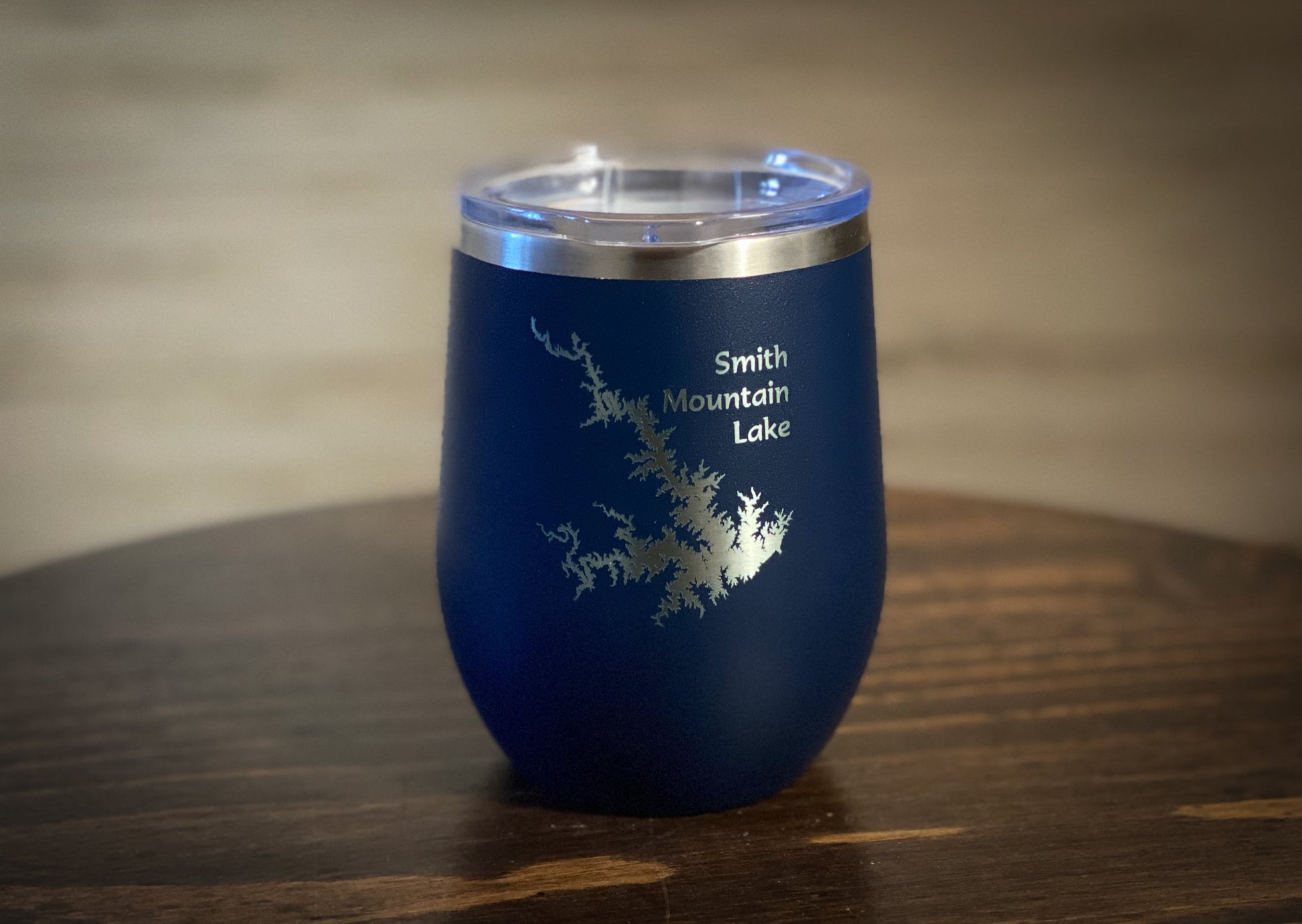 a blue wine glass sitting on top of a wooden table