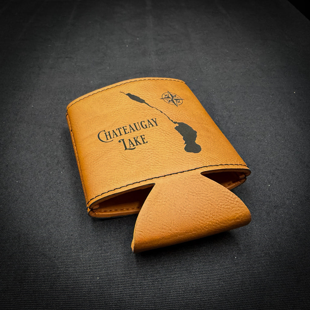 A tan leather wallet or card holder with the text "Chateaugray Lake" printed on it, along with a compass symbol.