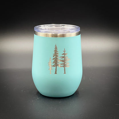 a teal colored cup with gold trees on it