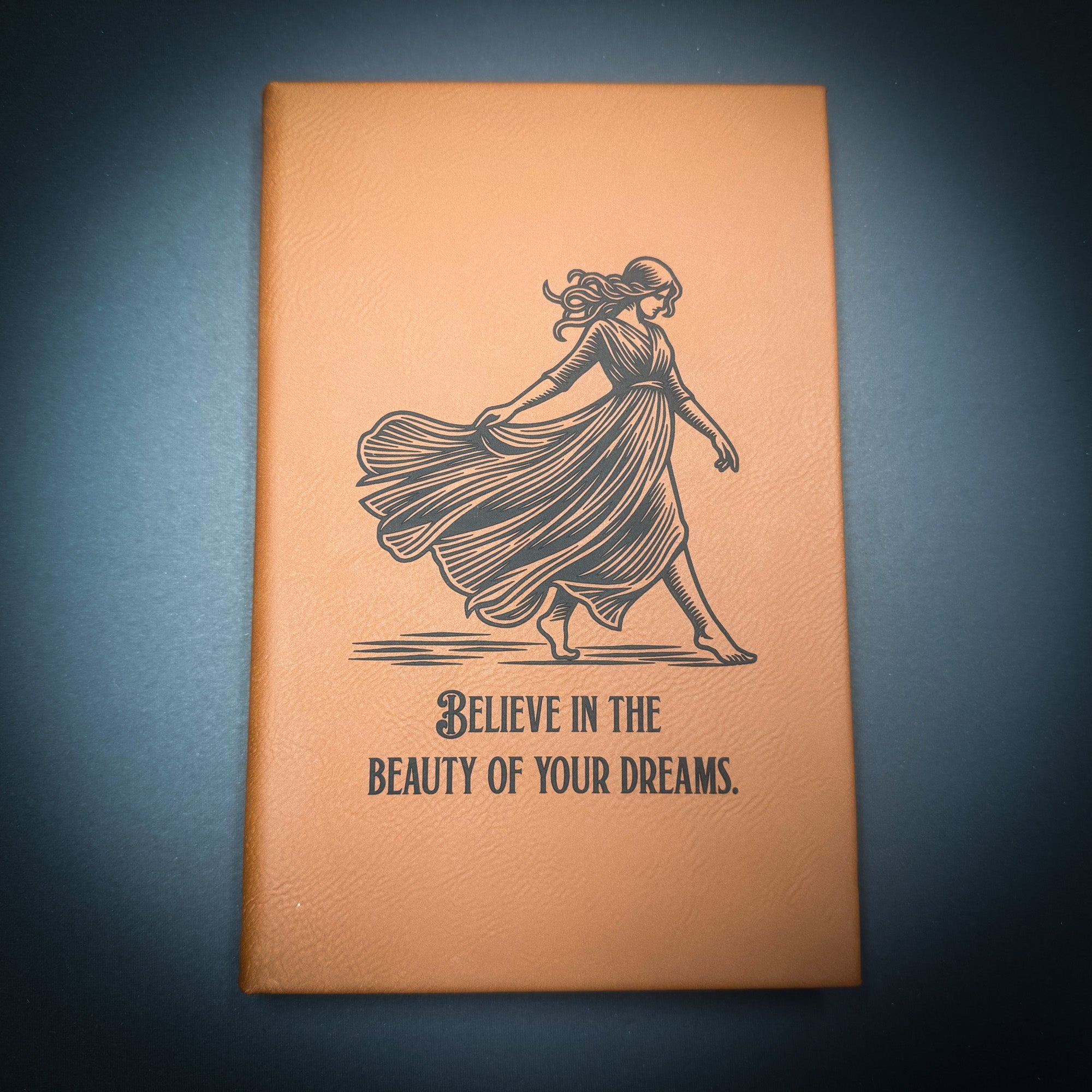 a book cover with an illustration of a woman in a flowing dress and the text "Believe in the beauty of your dreams."