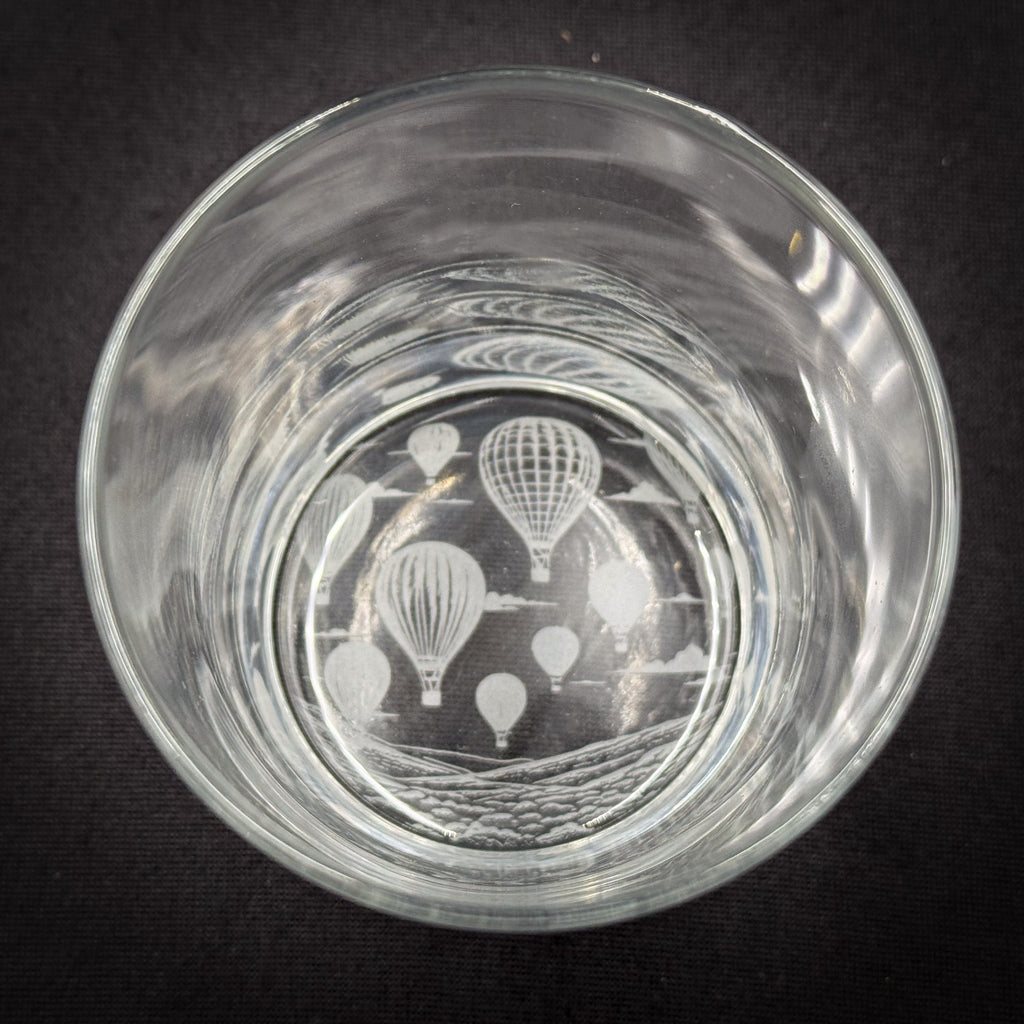 a clear glass with a design of hot air balloons printed on it.