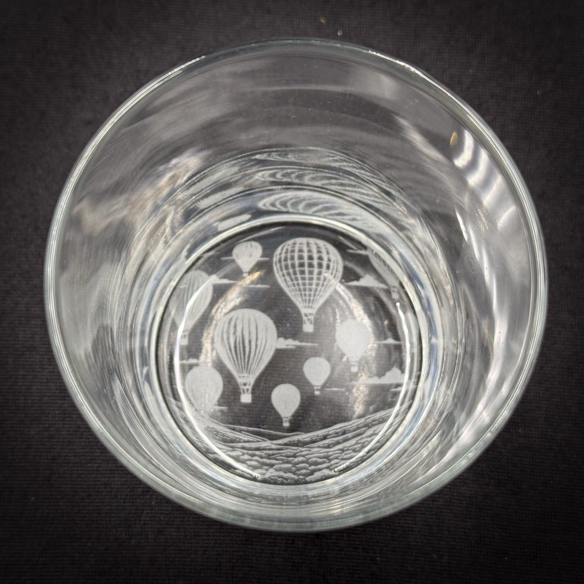 a clear glass with a design of hot air balloons printed on it.