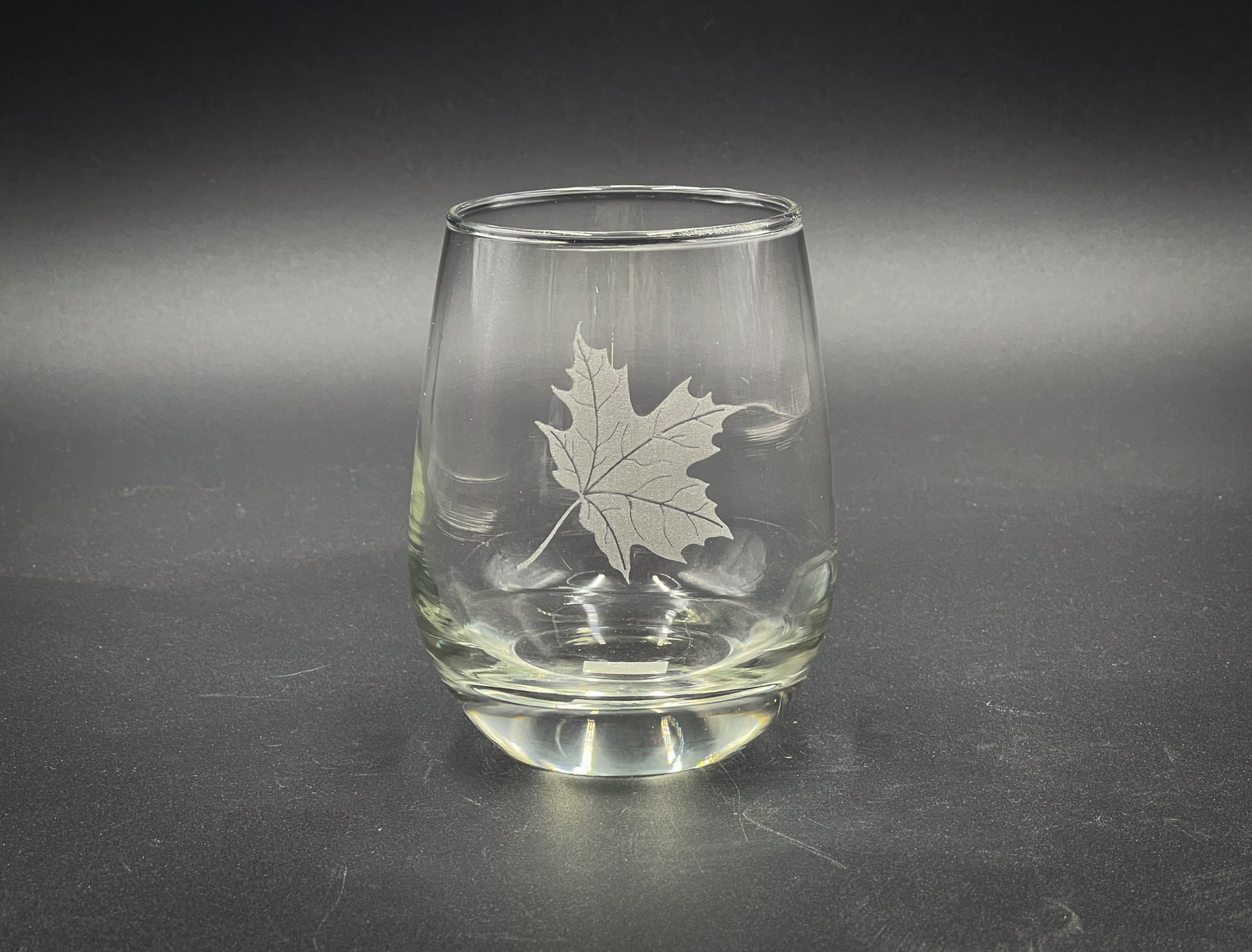 a glass with a leaf etched on it