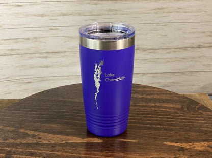 a purple tumbler sitting on top of a wooden table