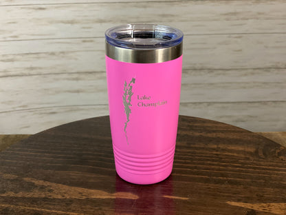a pink tumbler sitting on top of a wooden table