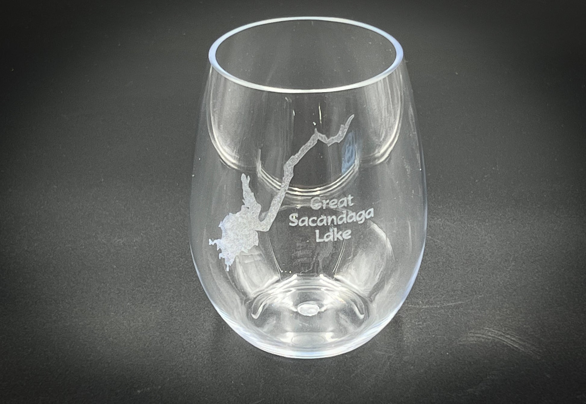 a clear wine glass with a bird etched on it