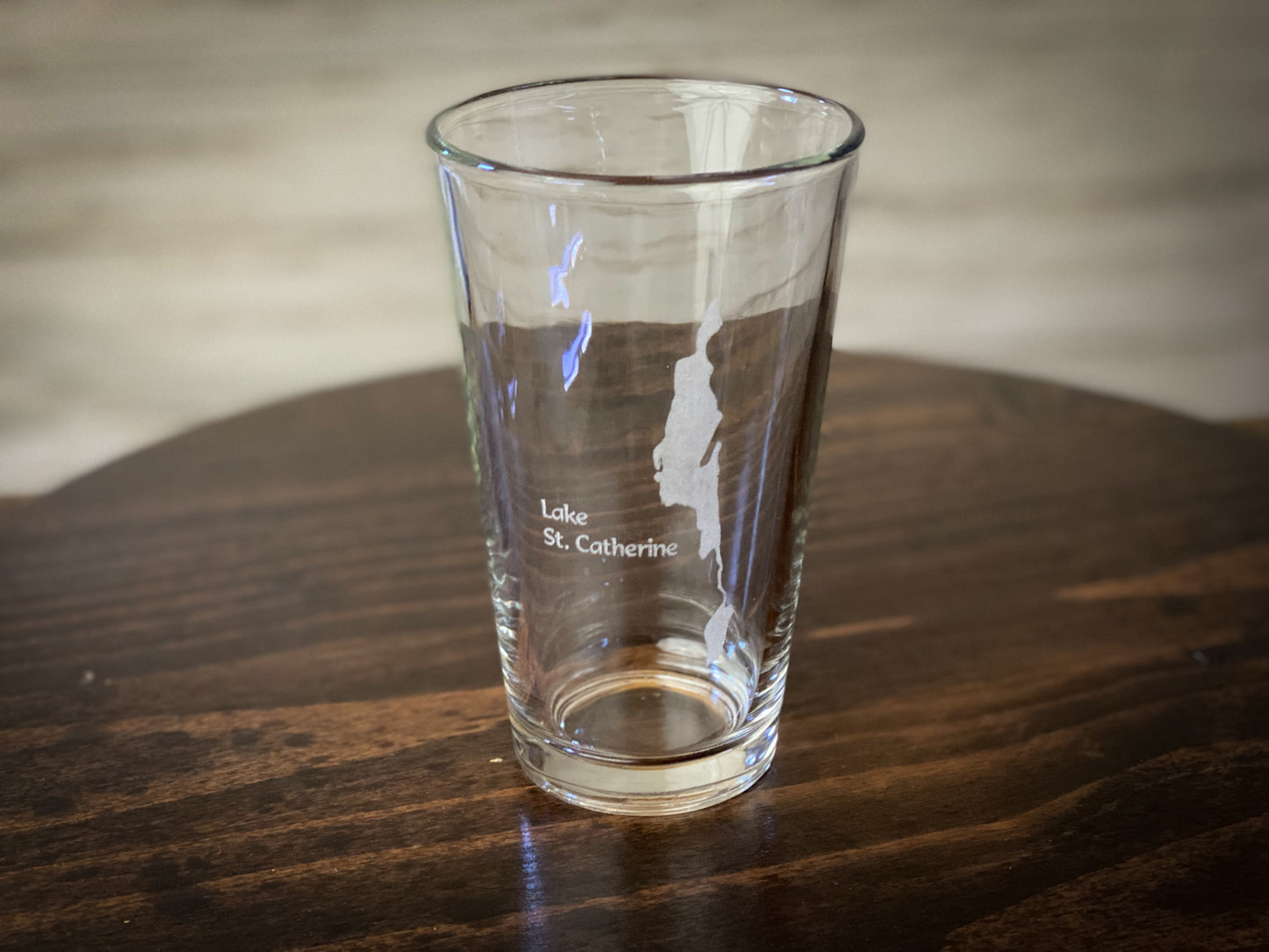 a clear glass sitting on top of a wooden table