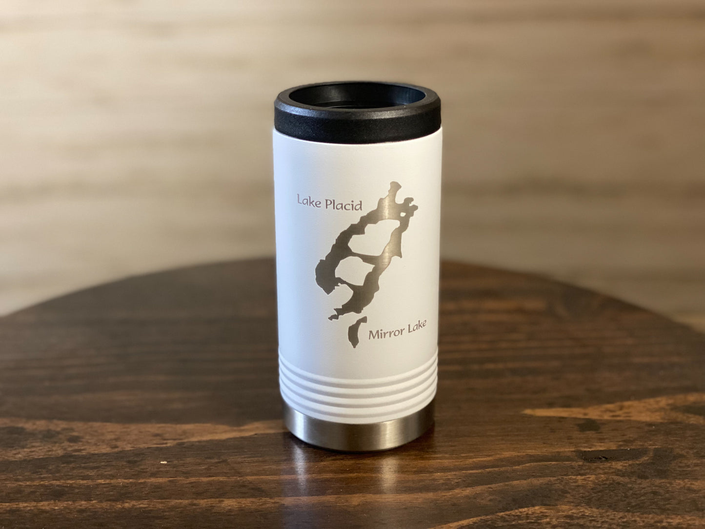 a travel mug sitting on top of a wooden table