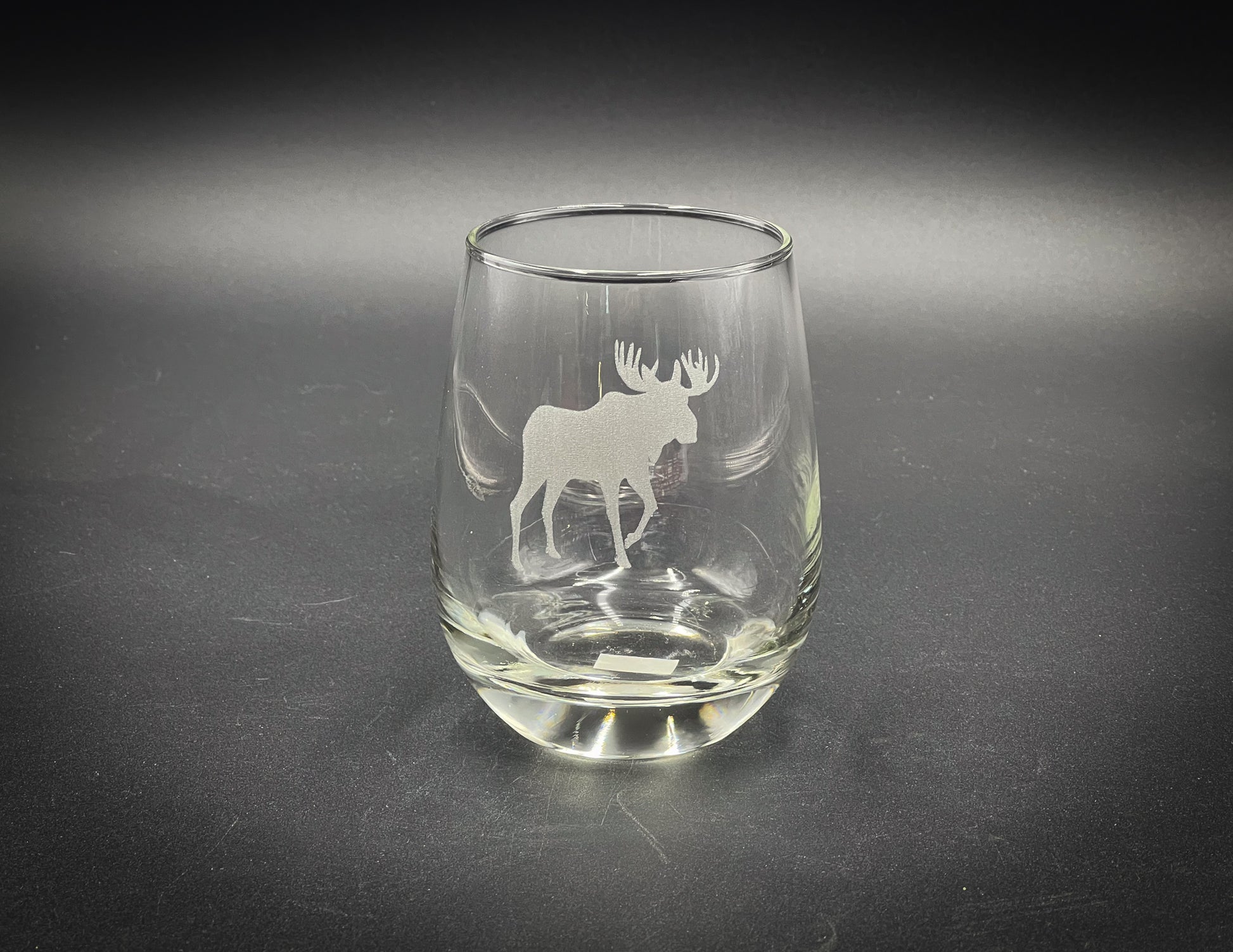 a glass with a moose etched on it