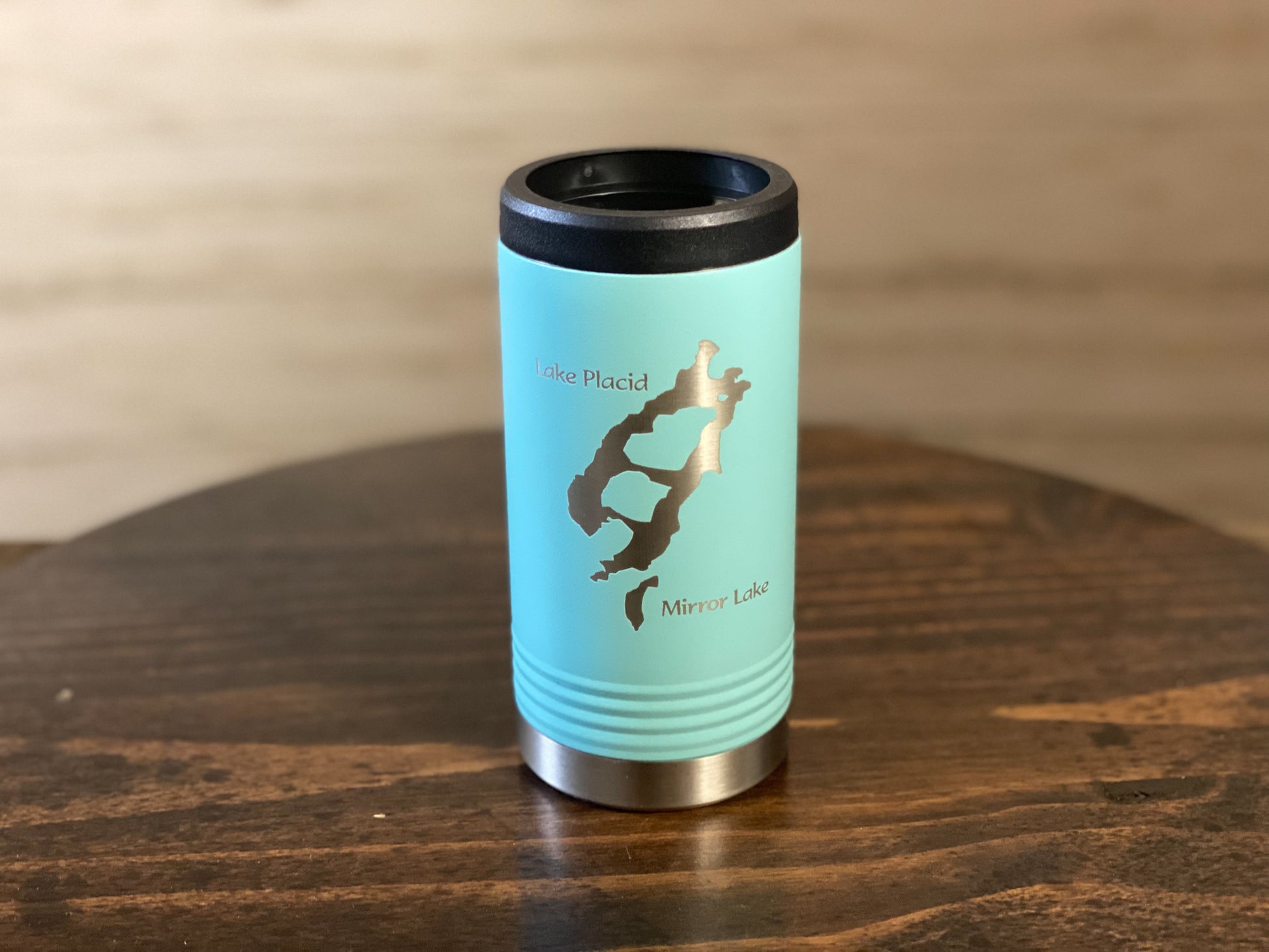 a blue travel mug sitting on top of a wooden table