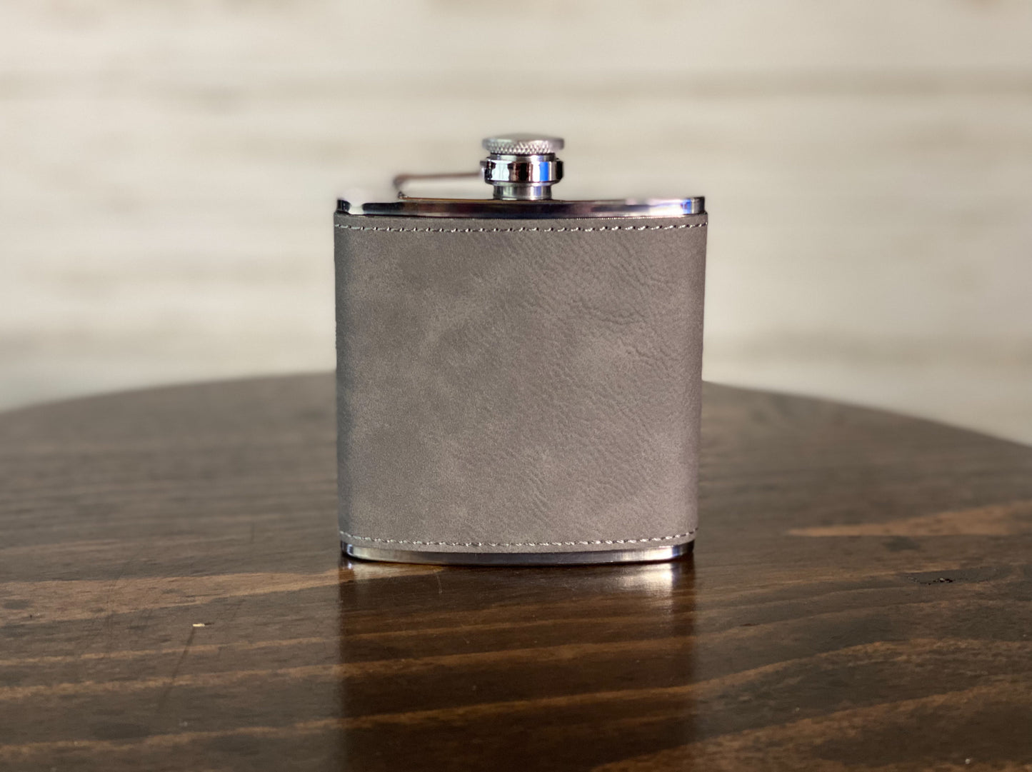 a leather flask flask on a wooden table