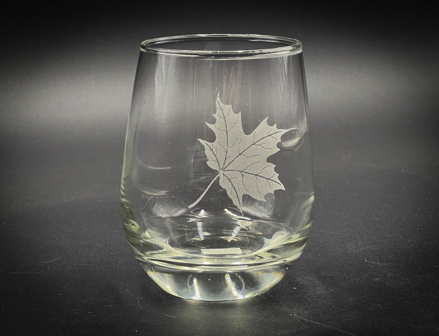 a glass with a leaf etched on it