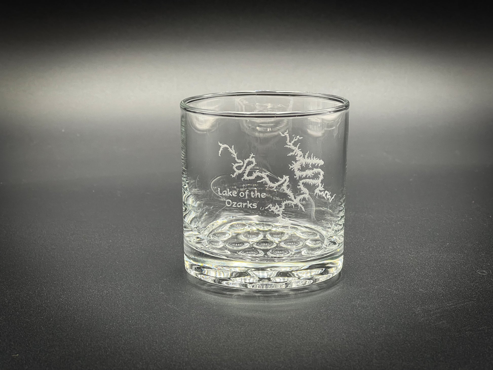 a glass with a design on it sitting on a table