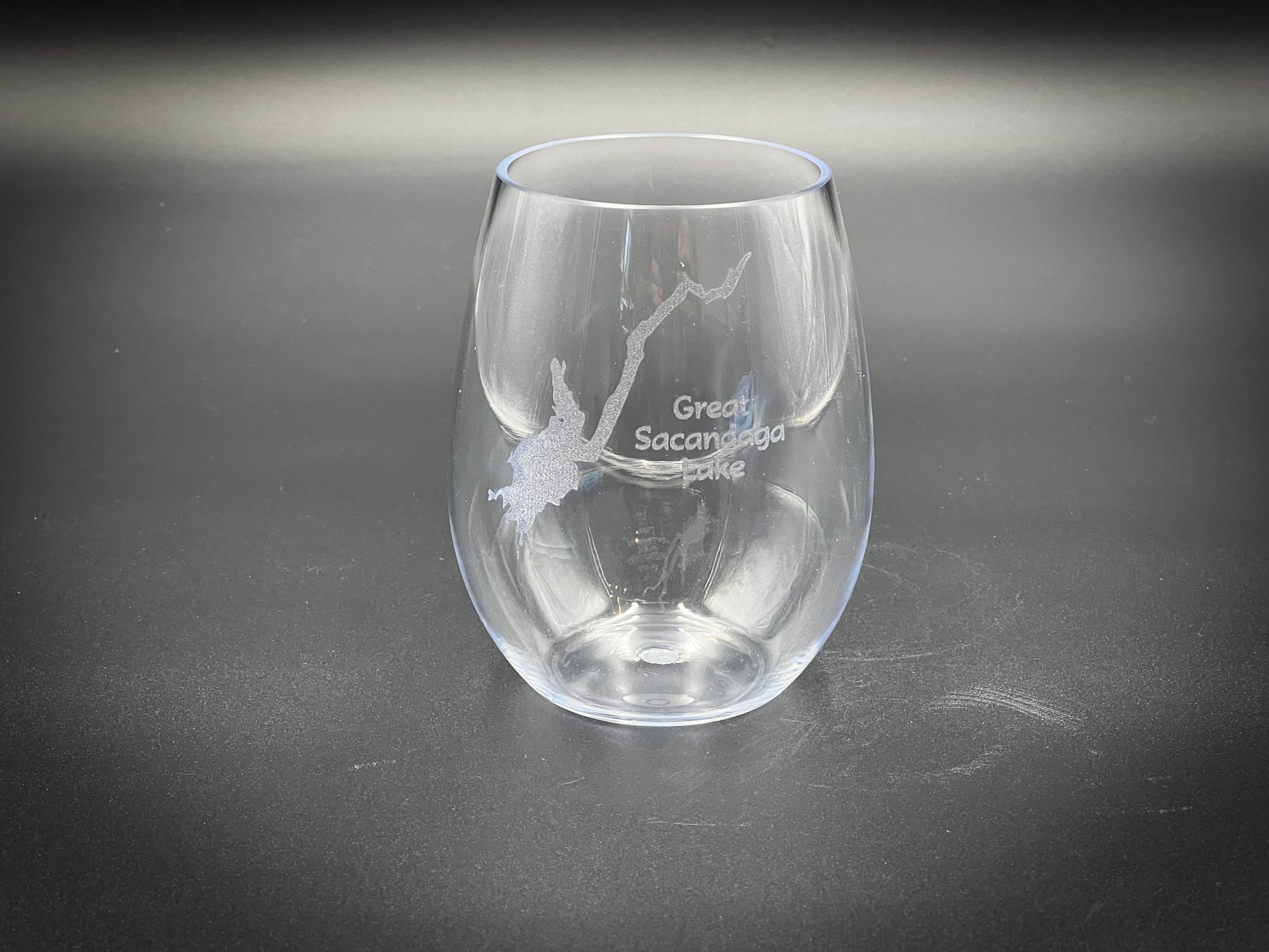 a clear wine glass with a branch etched on it