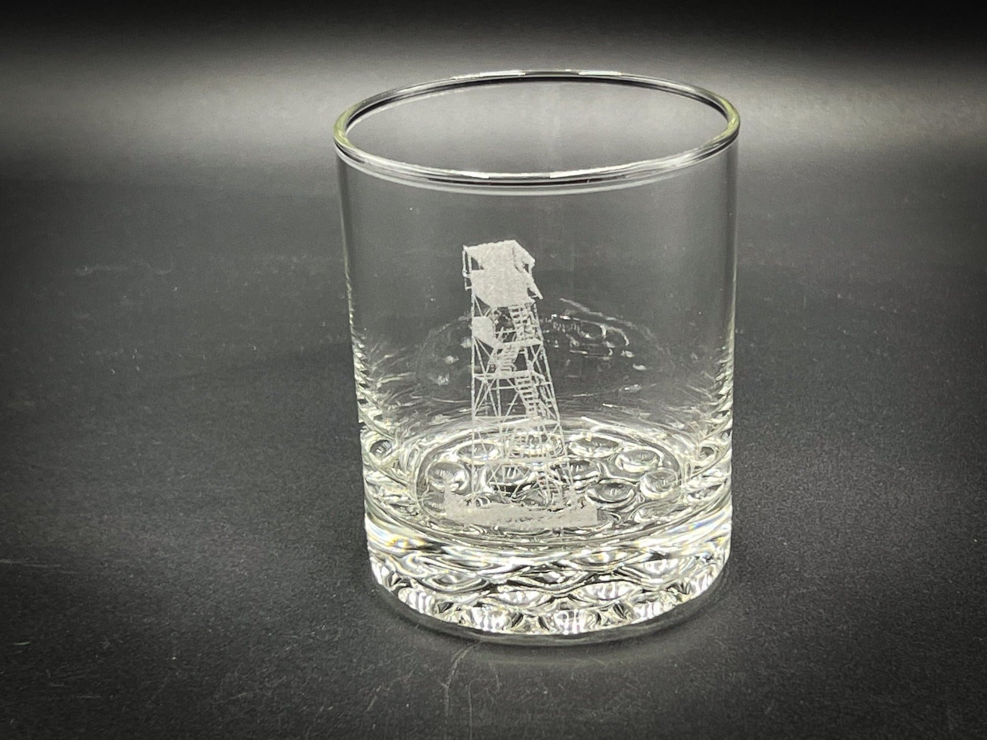 a glass with a picture of a lifeguard tower on it